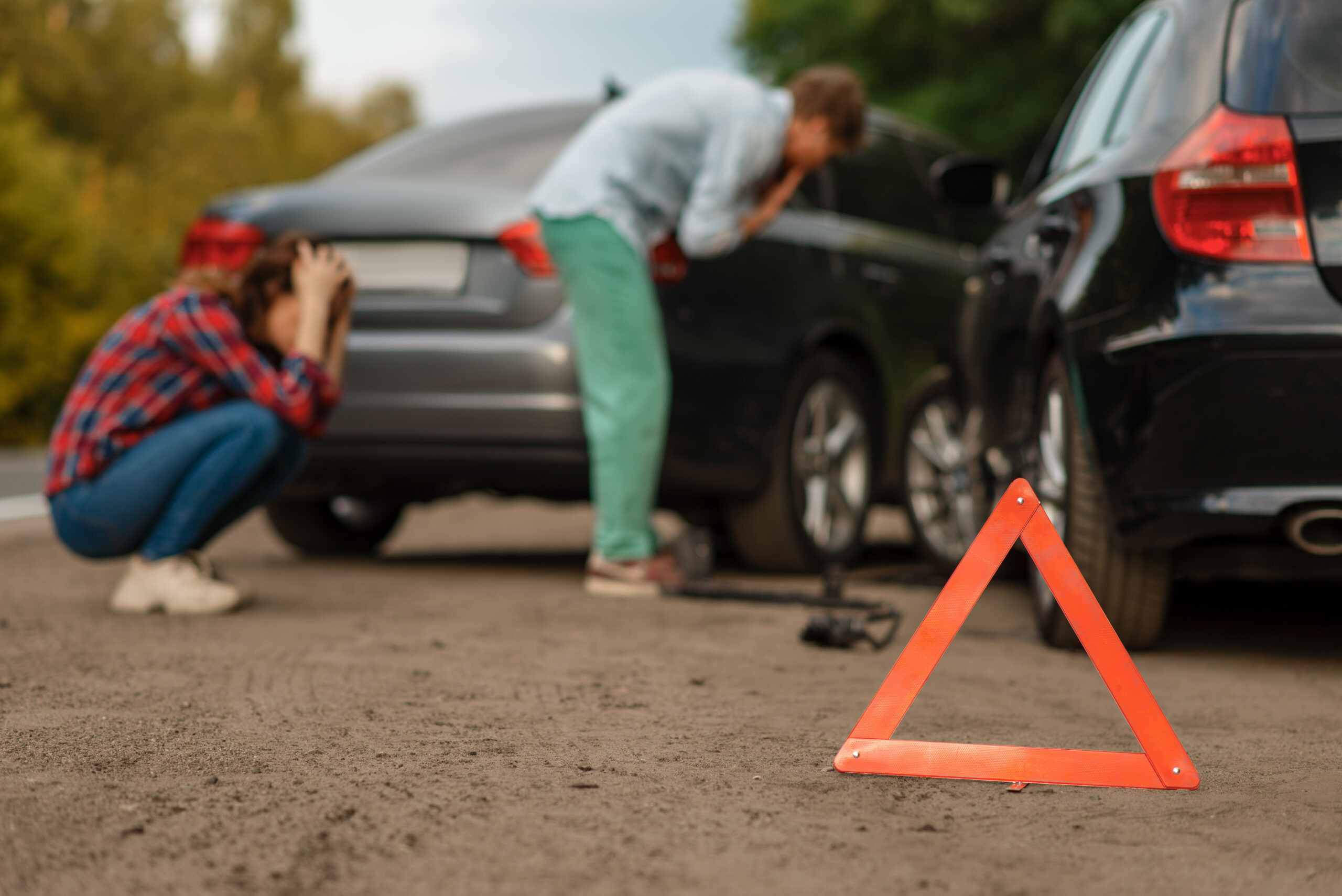 Car accident on road, male and female drivers. Automobile crash, emergency stop sign. Broken automobile or damaged vehicle, auto collision on highway